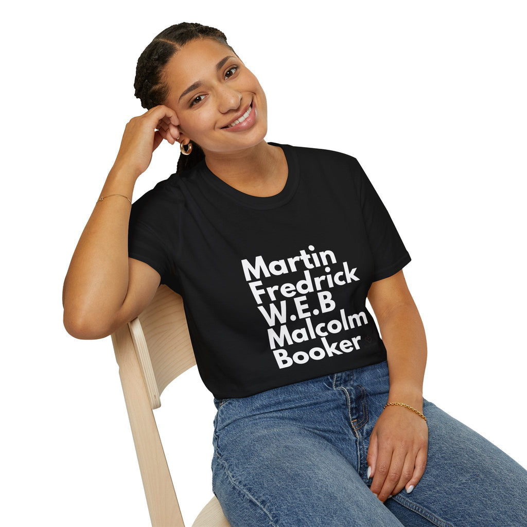 Person wearing a black t-shirt with black leaders in white text sitting on a chair.