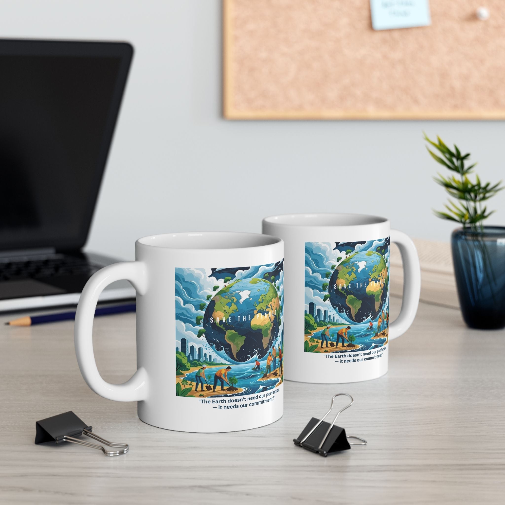 Two eco-friendly ceramic mugs with Earth-themed designs on a desk with a laptop and plant.