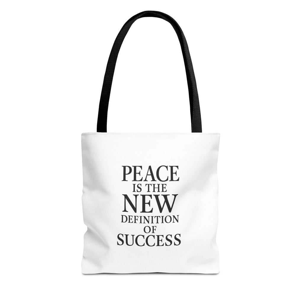 White tote bag with black text 'PEACE IS THE NEW DEFINITION OF SUCCESS' on a white background