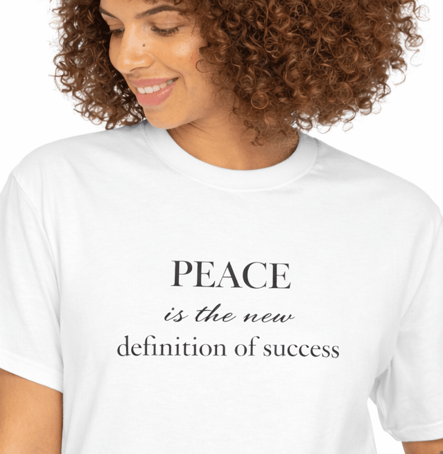 Woman wearing a white t-shirt with Relatable Designs 'Peace is the new definition of success' text.