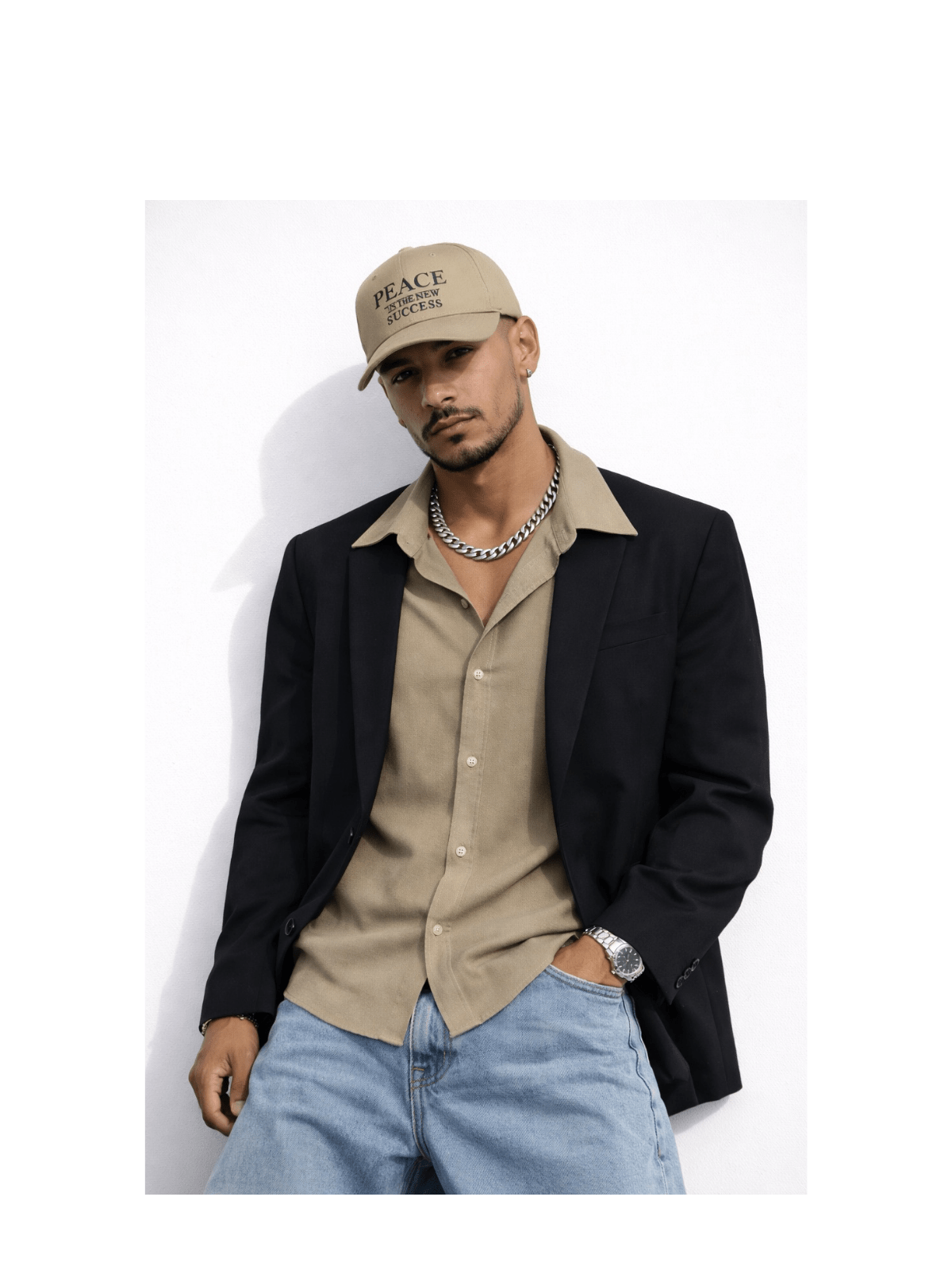 Male model wearing khaki embroidered Peace cap with casual blazer outfit