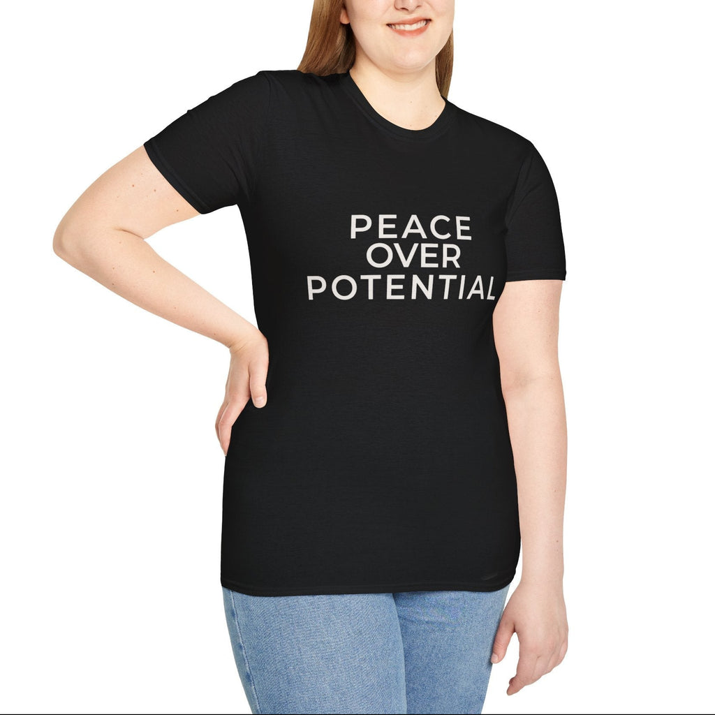 Person wearing a black t-shirt with 'PEACE OVER POTENTIAL' text on a white background