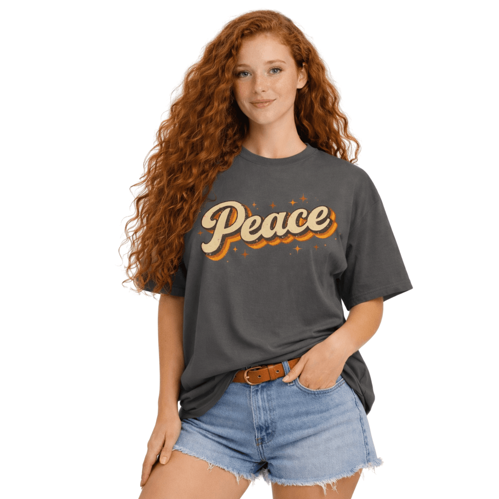 Woman wearing a gray t-shirt with 'Peace' printed on it, standing against a white background