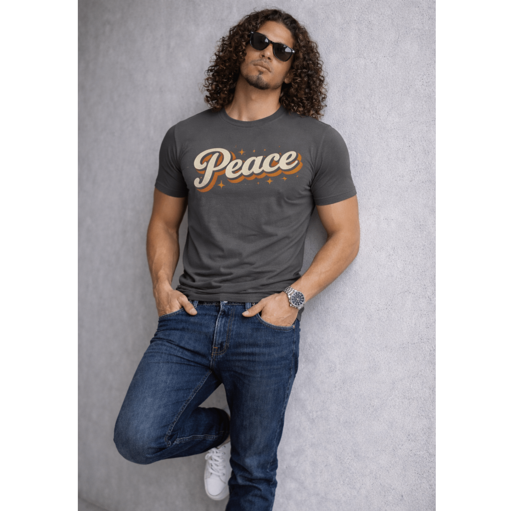 Man wearing a gray t-shirt with 'Peace' printed on it, sunglasses, and blue jeans against a gray background.