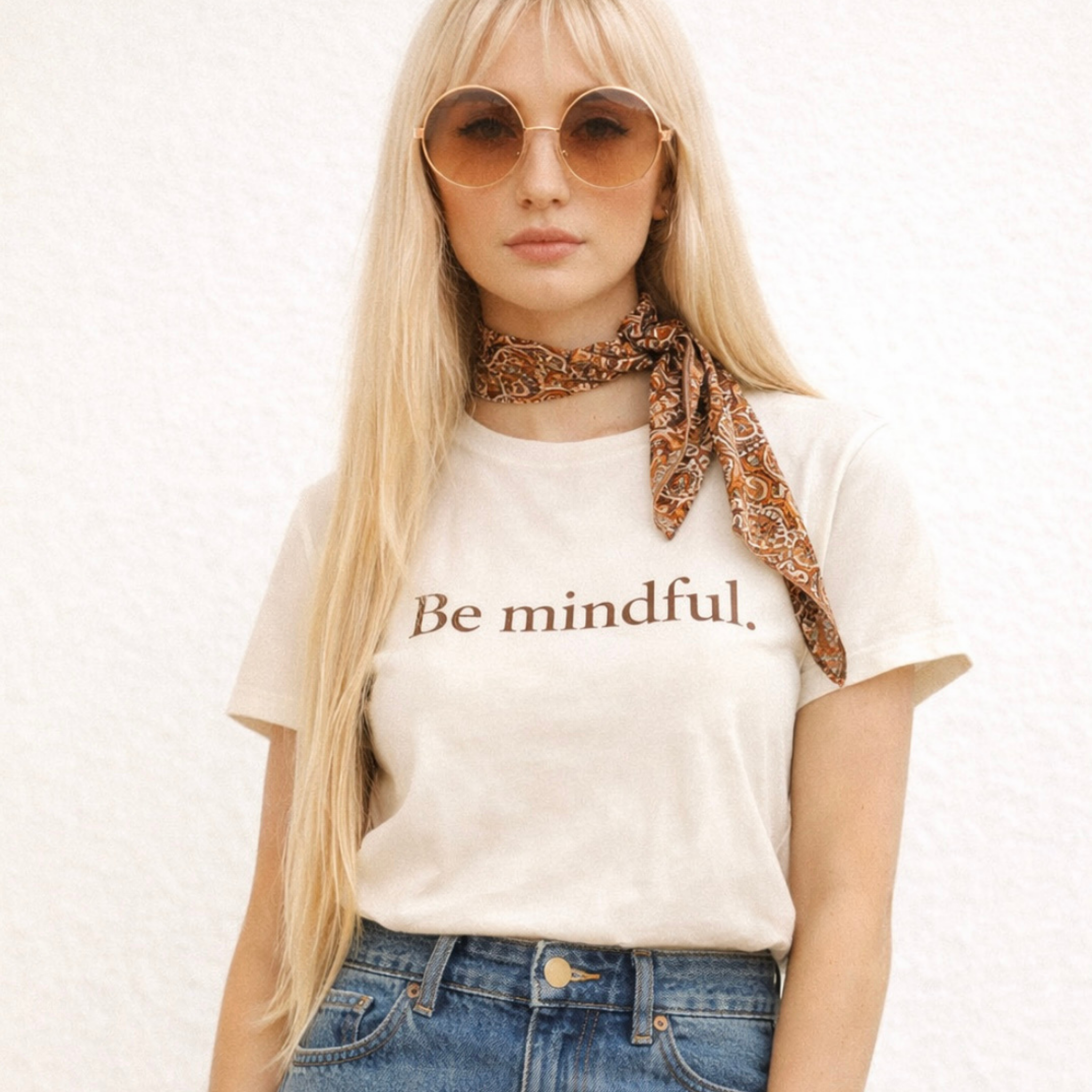 Woman wearing a 'Be mindful' t-shirt with sunglasses and a scarf on a white background by Relatable Designs