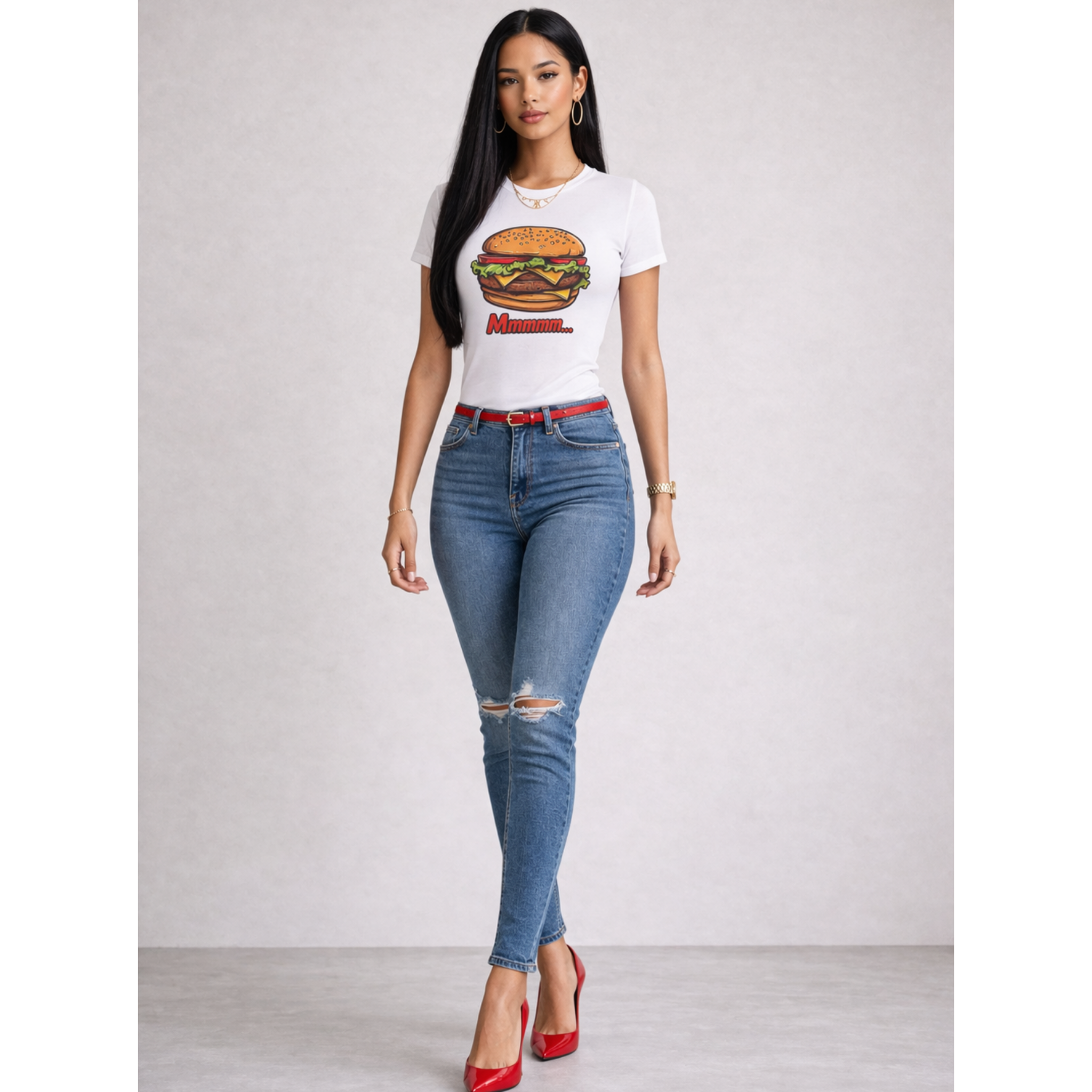 Woman wearing a white t-shirt with a graphic burger design and blue jeans on a plain background