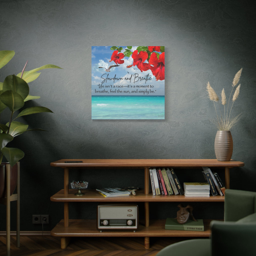 Decorative wall art with tropical red flowers and text on a gray wall above a wooden shelf.
