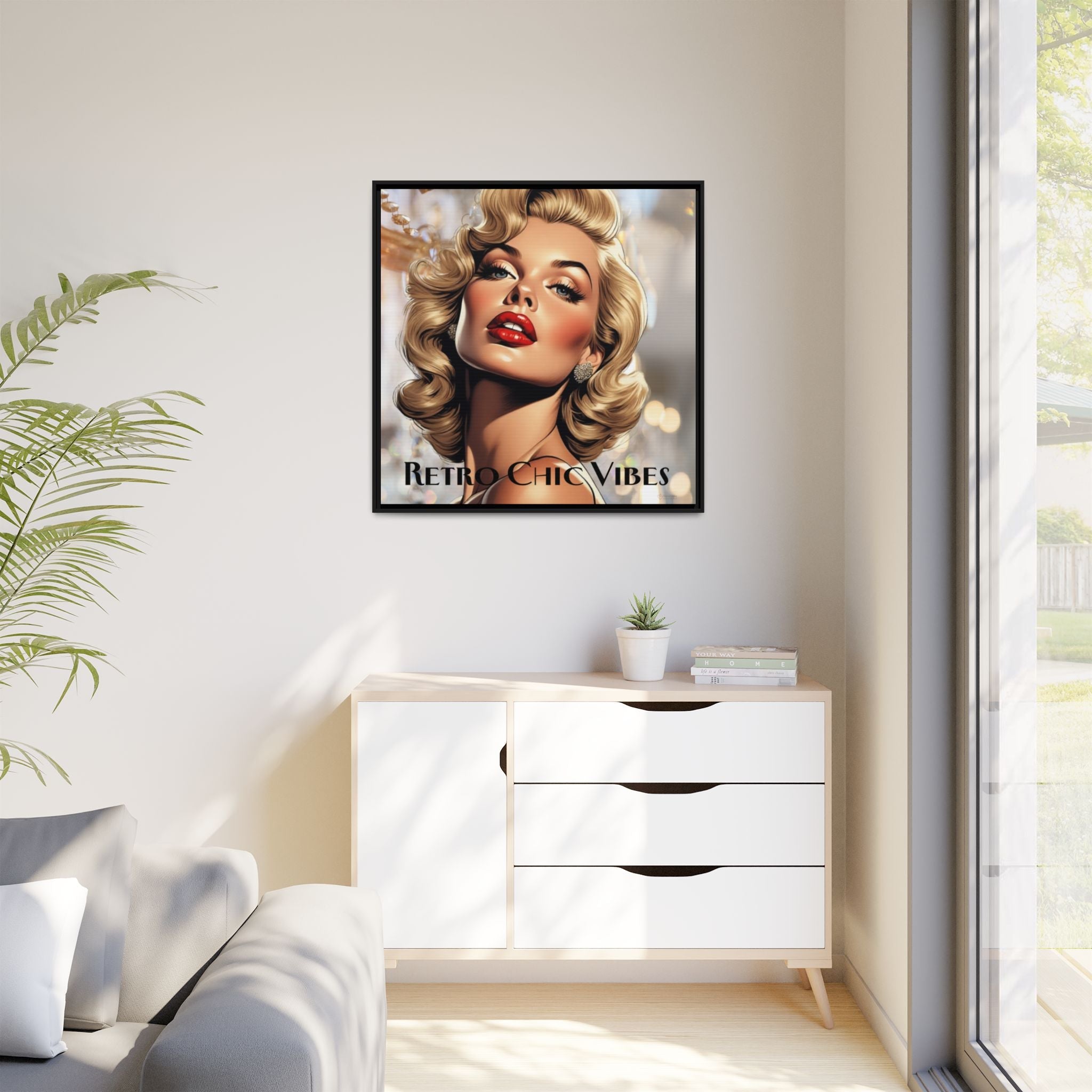 Framed retro artwork of a stylized portrait of woman on a wall above a white cabinet.