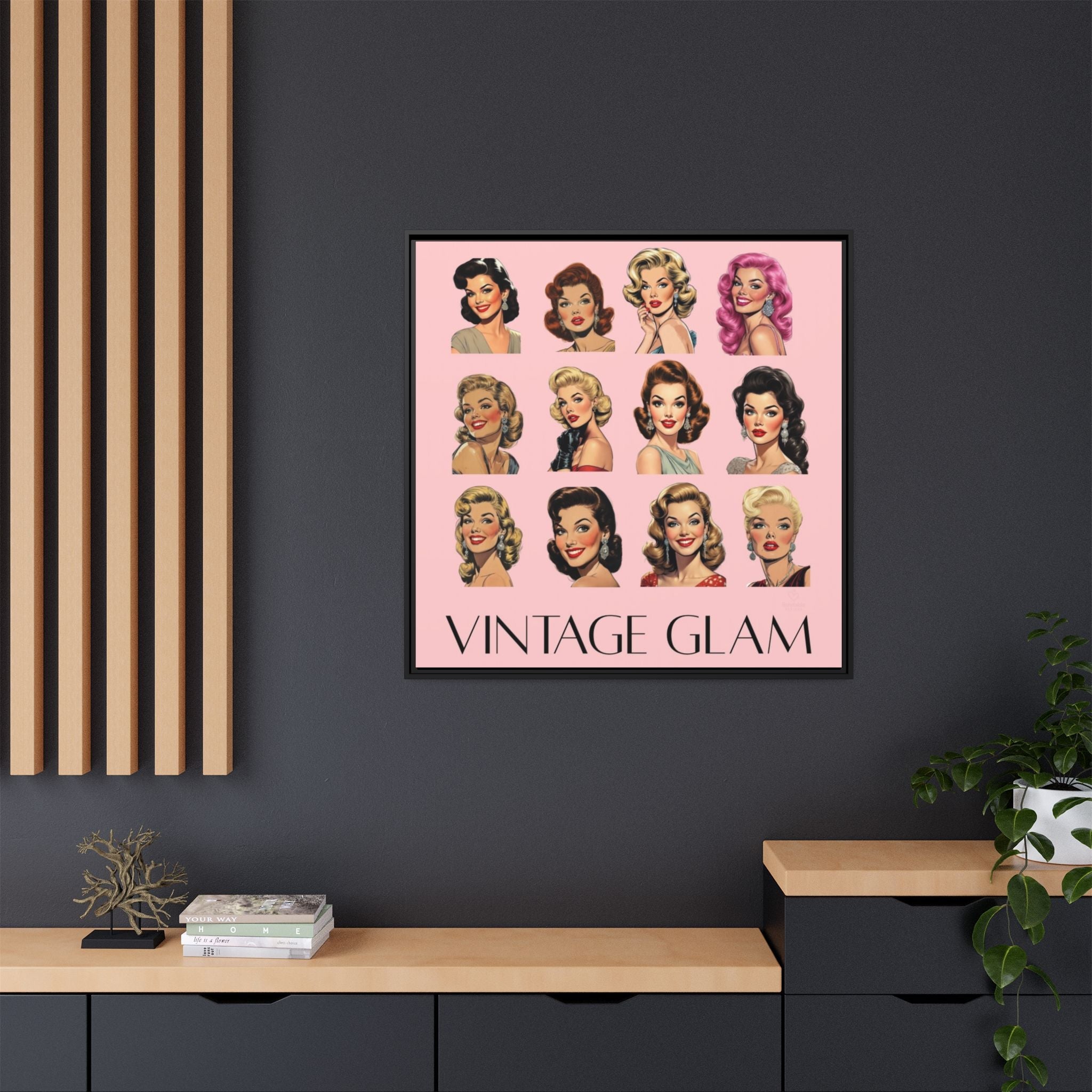 Framed 'Vintage Glam' wall art with illustrations of women's hairstyles on a pink background, displayed on a dark wall.