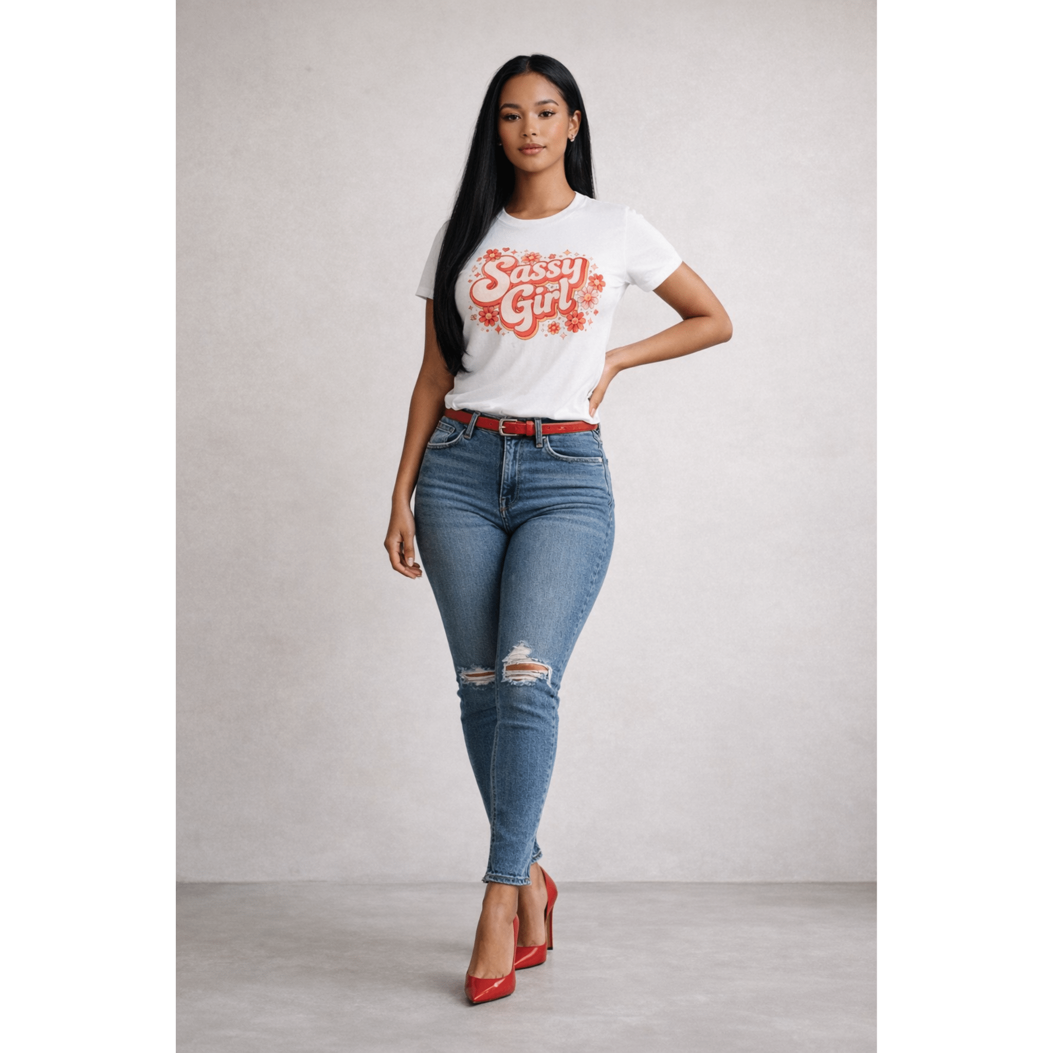 Woman wearing a 'Sassy Girl' t-shirt, blue jeans, and red shoes against a plain background