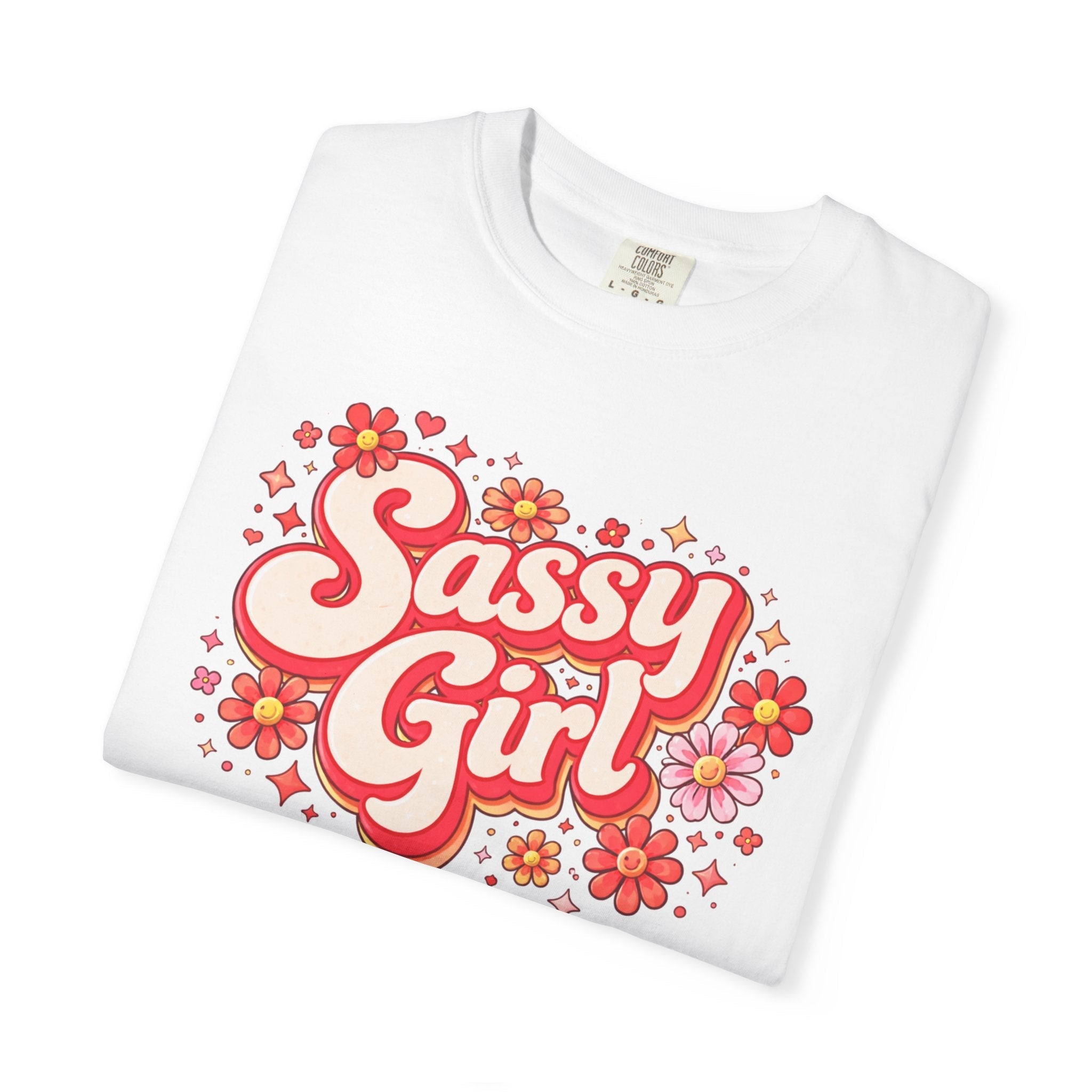 Folded White t-shirt with pink Sassy Girl' text and floral designs on a white background