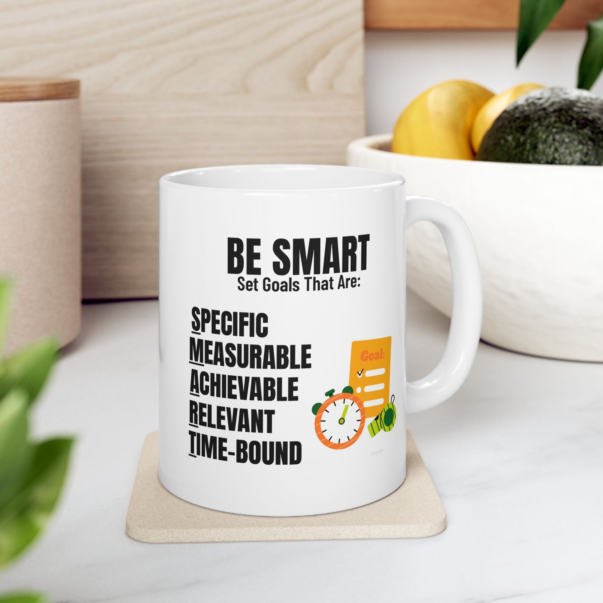 BE SMART White ceramic mug with motivational quote in black text on a coaster, surrounded by kitchen items.