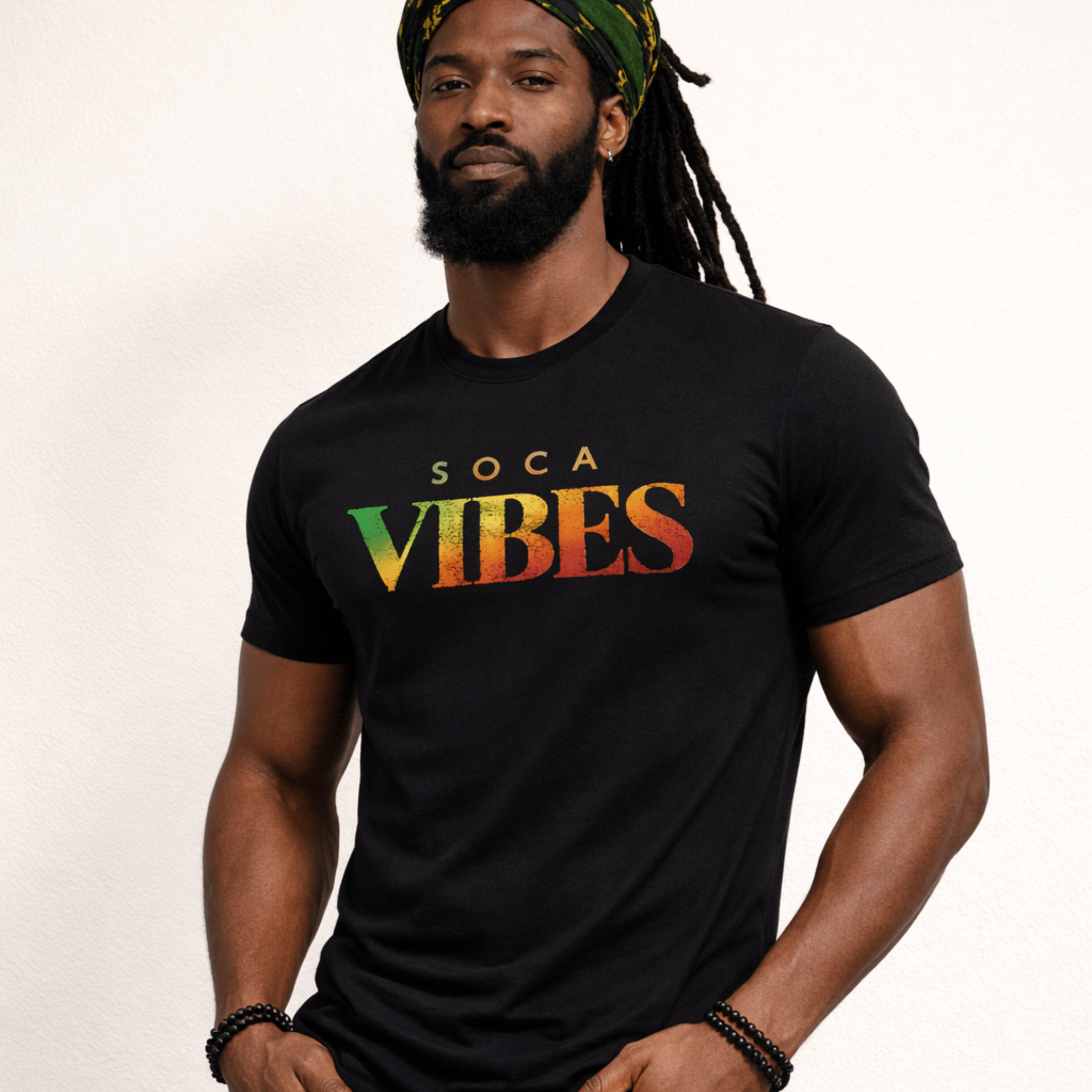 Male model wearing a black t-shirt with 'Soca Vibes' text in Rastafarian colors on a white background