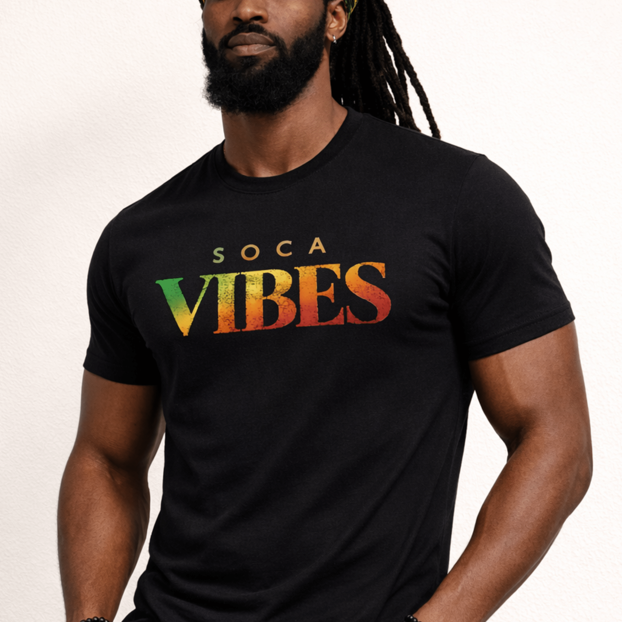 Man wearing a black t-shirt with 'Soca Vibes' text in Rasta colors on a plain background by Relatable Designs.