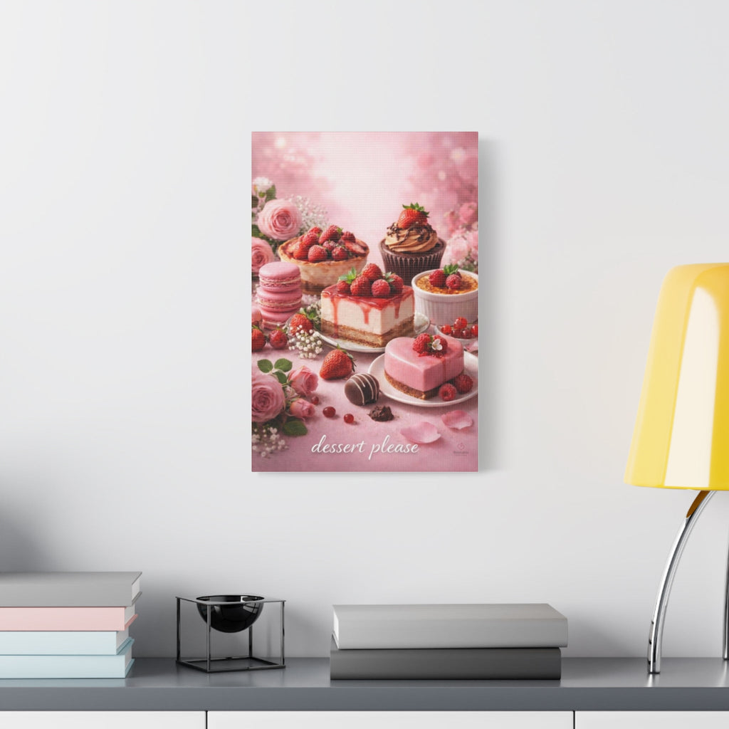 Unframed artwork of desserts in pink background on a table with 'dessert please' text, displayed on a wall above a desk.