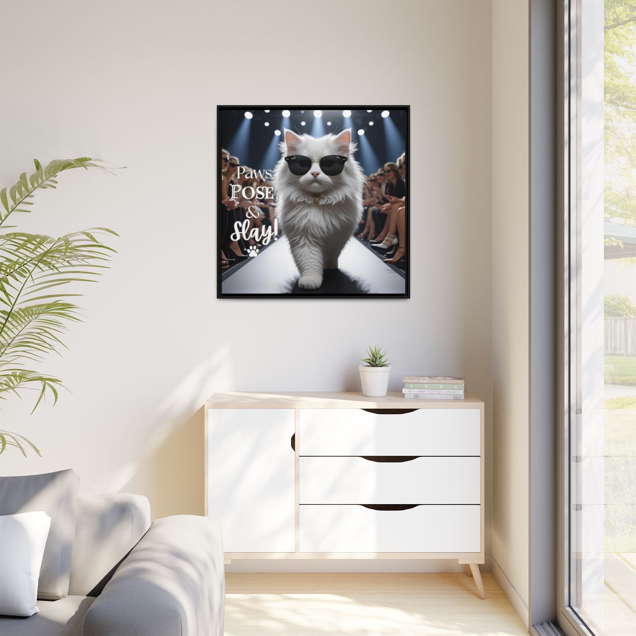 Framed picture of a fashion cat wearing sunglasses on a wall in a modern living room.