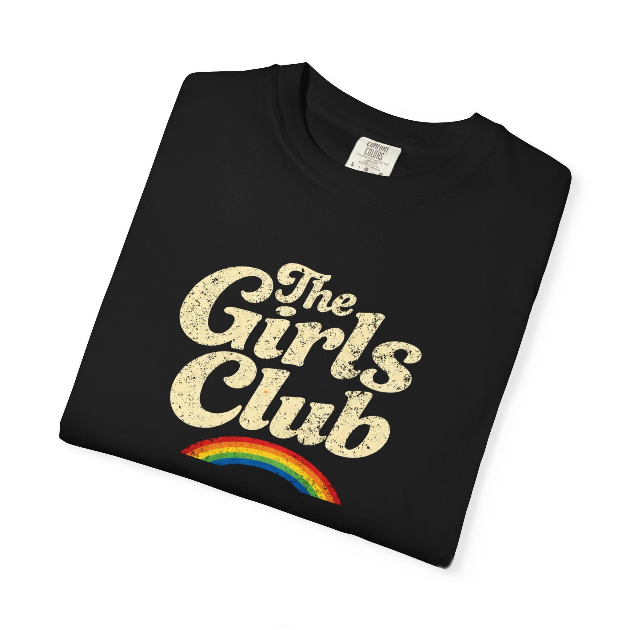 Folded black t-shirt with 'The Girls Club' text and rainbow design on a white background