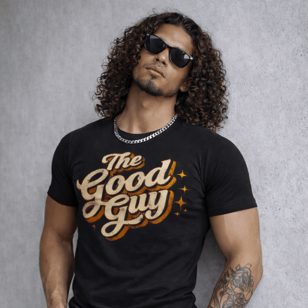 Man wearing a black t-shirt with 'The Good Guy' text against a gray background by Relatable Designs