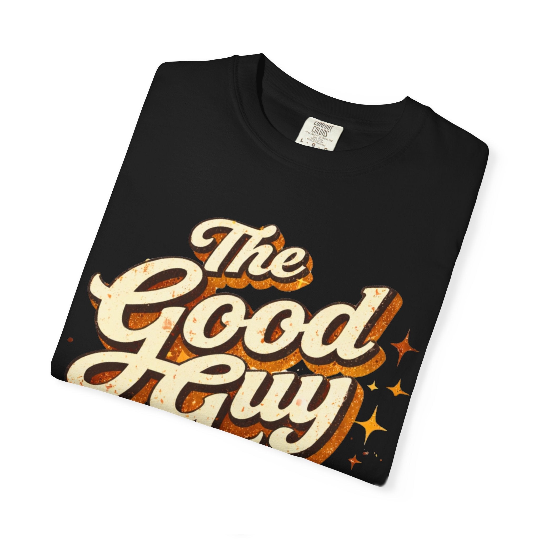 Folded black t-shirt with 'The Good Guy' text design on a white background