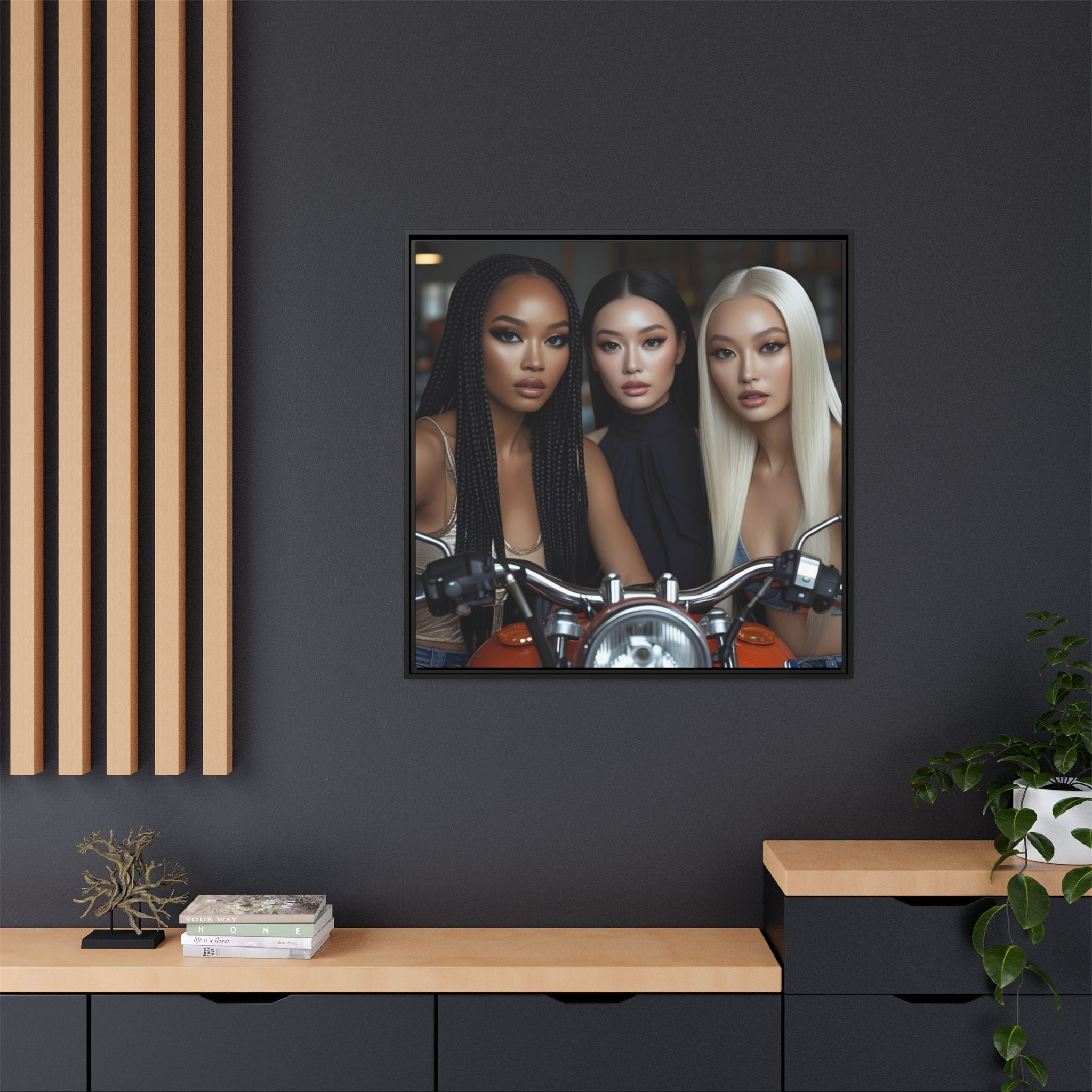 Framed urban artwork of three female fashion models on a motorcycle against a dark wall.