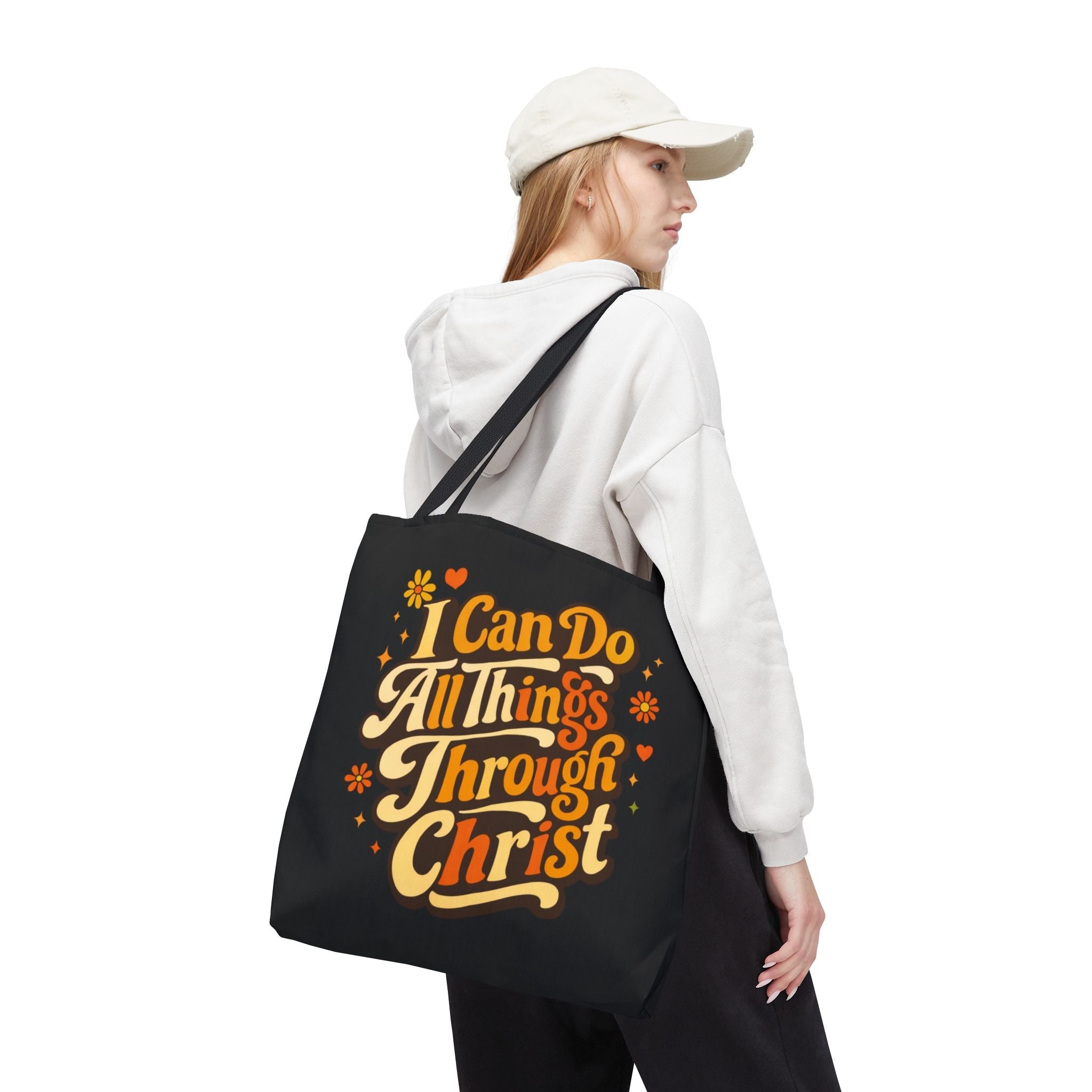 Women carrying a black tote bag with motivational text in vintage yellow and orange on a white background