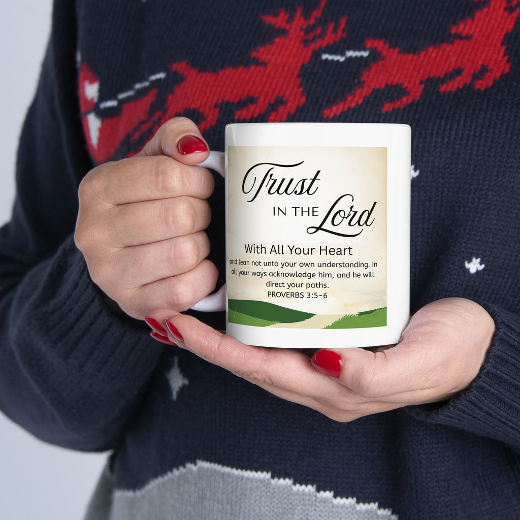 Person holding a mug with a 'Trust in the Lord' quote against a festive sweater background