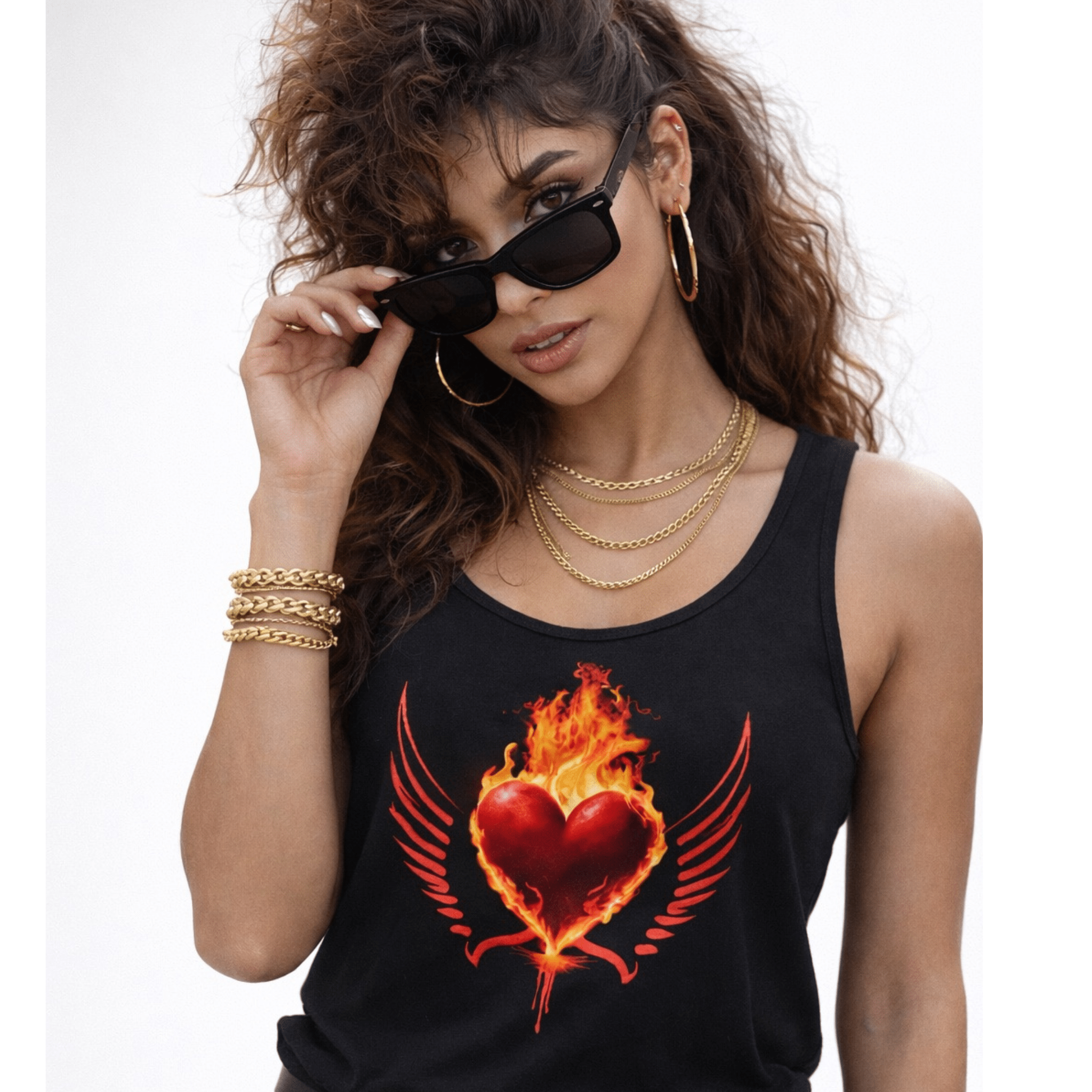 Woman wearing a black tank top with a fiery red heart design, holding sunglasses.