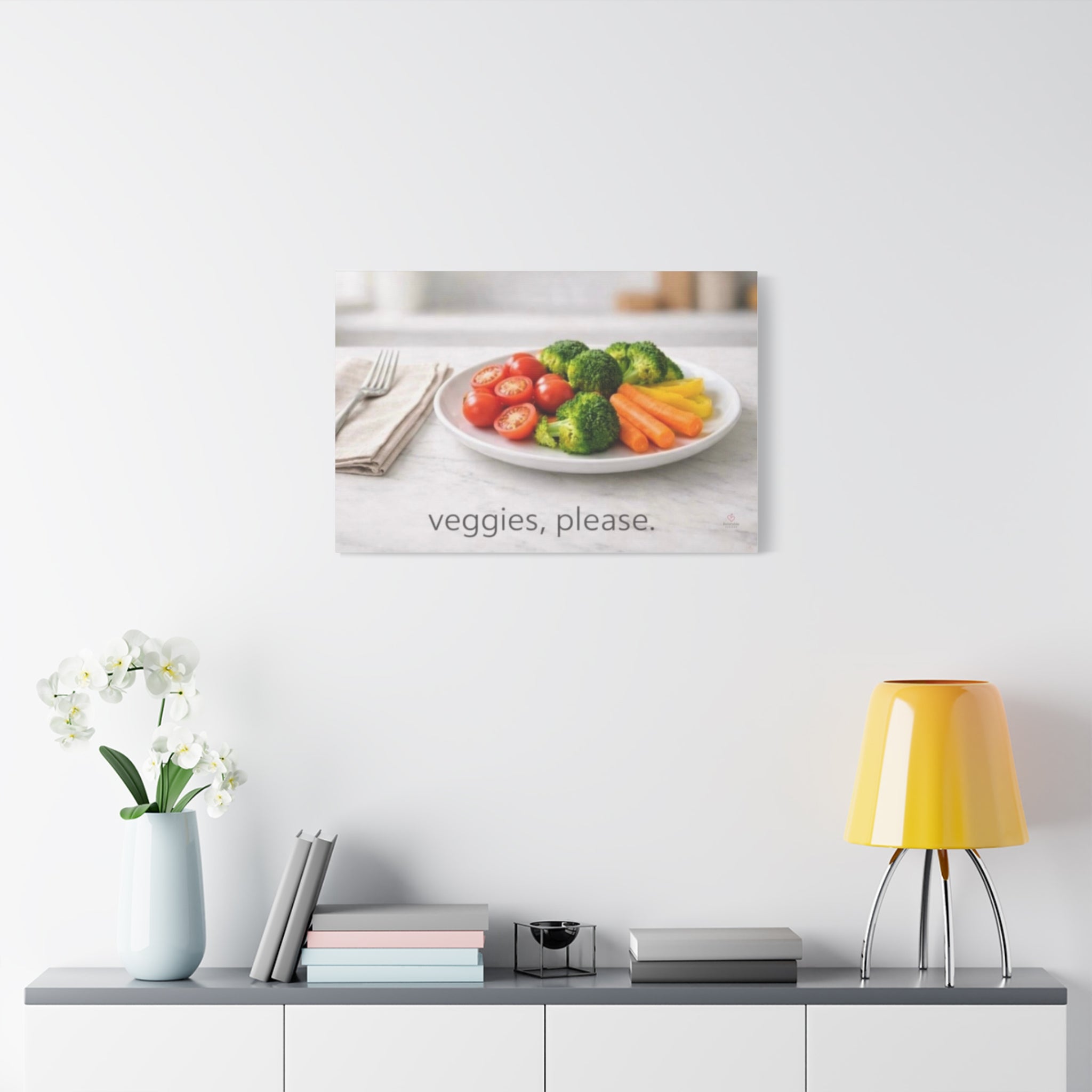 Modern interior wall art with a plate of vegetables, a vase with flowers, books, and a yellow lamp.