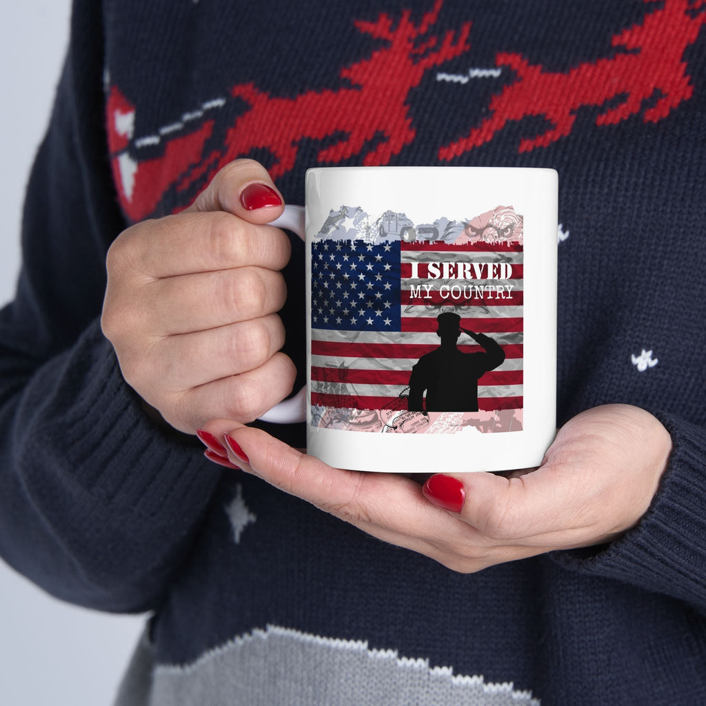 Person holding a mug with 'I Served My Country' design against a dark sweater with red deer pattern.