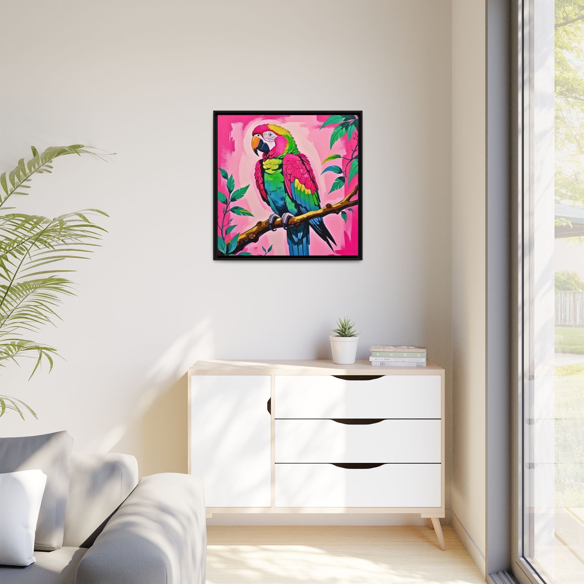 Colorful tropical parrot painting on a wall above a white dresser with a plant and books.