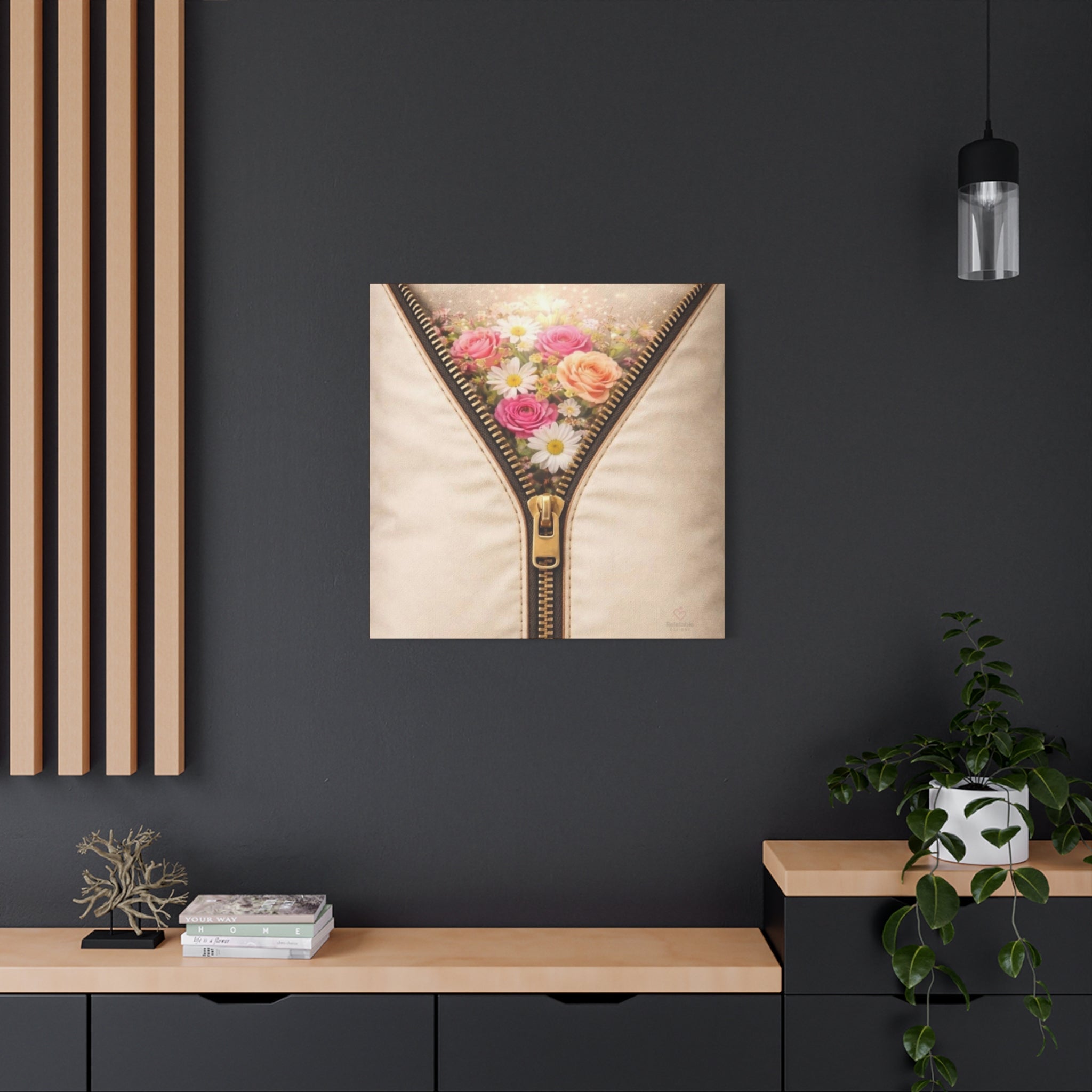 Creme wall art of a zipper with pastel flowers  being revealed on a dark wall above a wooden shelf.